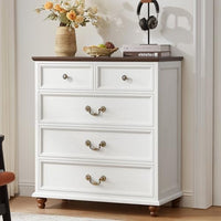 White nightstand with three drawers and decorative metal knob pulls, turned feet