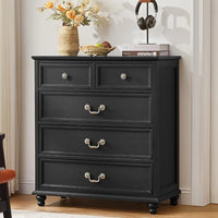 Black nightstand with three drawers and decorative metal knob pulls, turned legs
