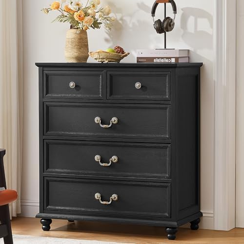 Black nightstand with three drawers and decorative metal knob pulls, turned legs