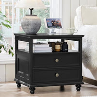 Black nightstand with two drawers and open shelf, brass knob pulls, turned legs
