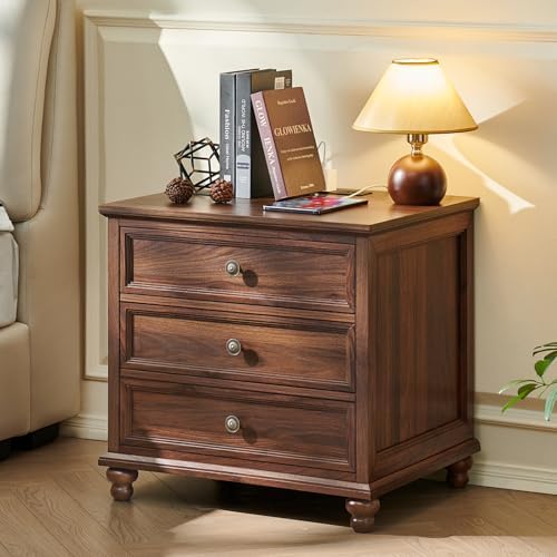 Brown wood nightstand with three drawers and round knob pulls on turned legs