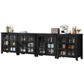 Black sideboard cabinet with glass doors and long countertop for serving.