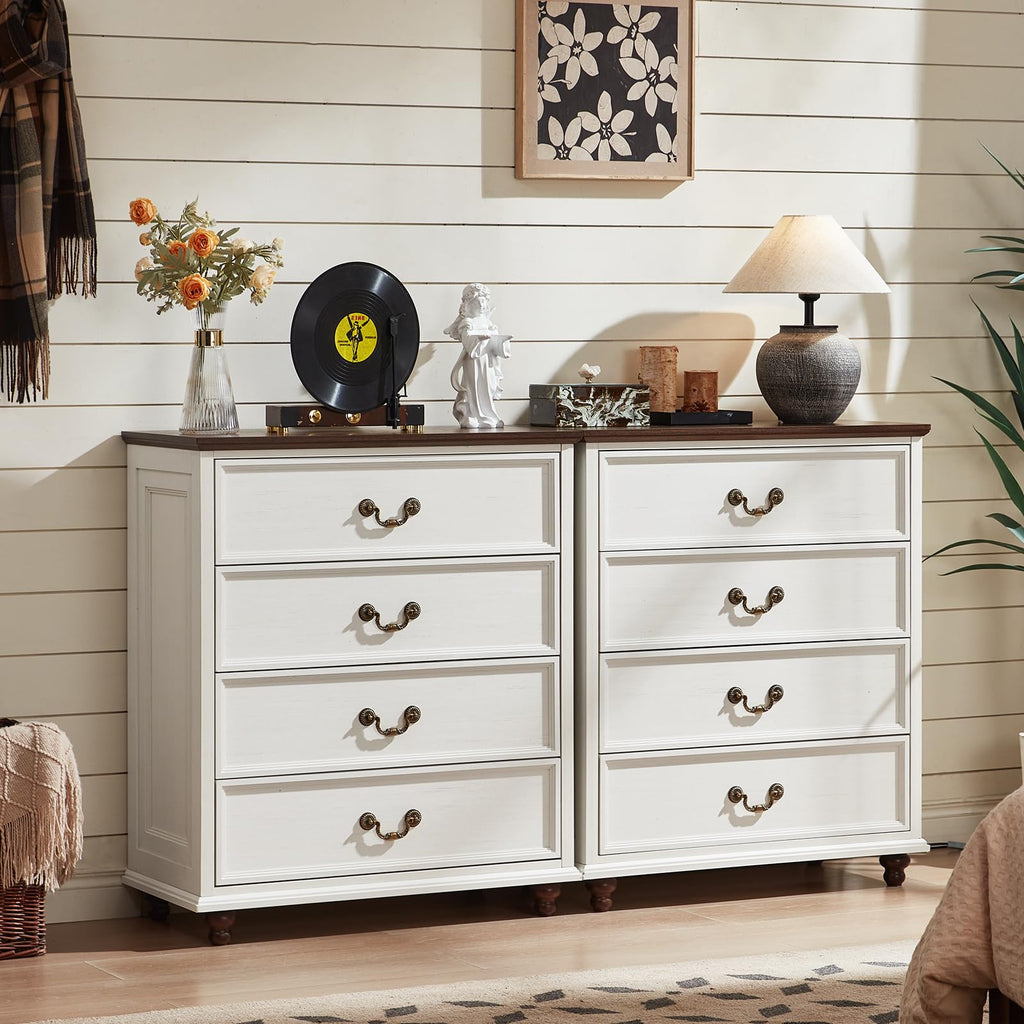 White wooden dresser with four drawers and curved metal handles.