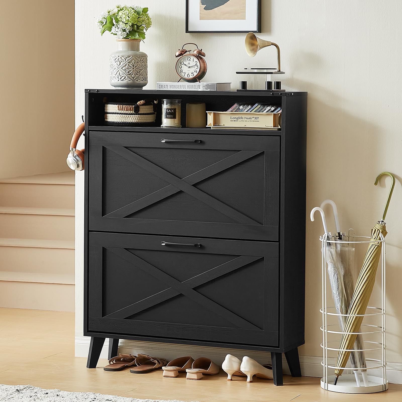 Black shoe storage cabinet with two flip drawers and X-pattern door panels, free-standing