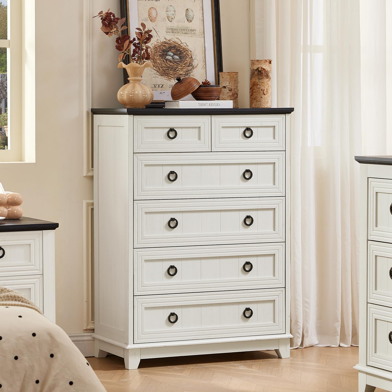 White painted farmhouse dresser with five drawers and round metal knobs.