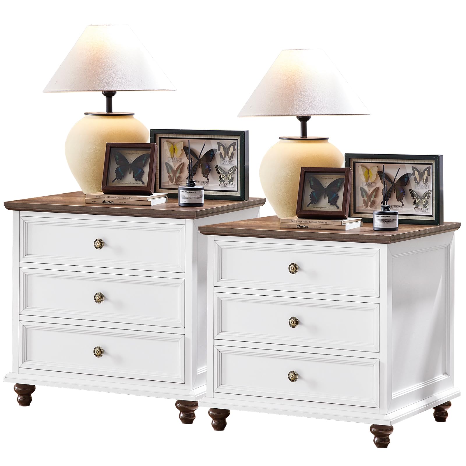White dresser pair with wood tops, butterfly art, and bronze drawer knobs.