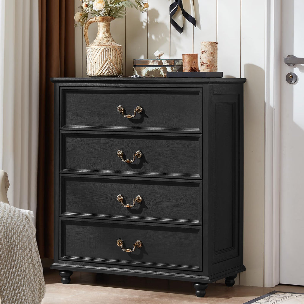 Black wood dresser with four drawers and bronze knobs, supported by short feet