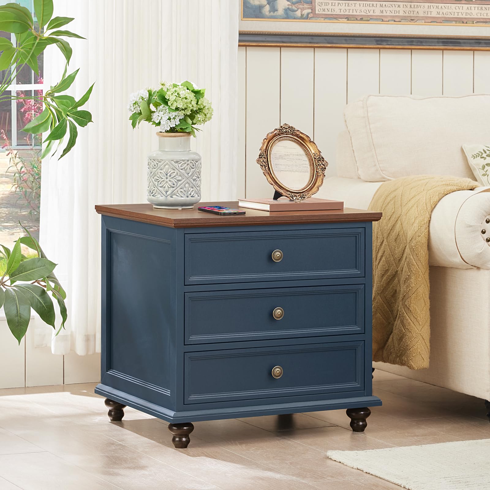 Navy blue 3-drawer dresser with round brass handles and short bun feet