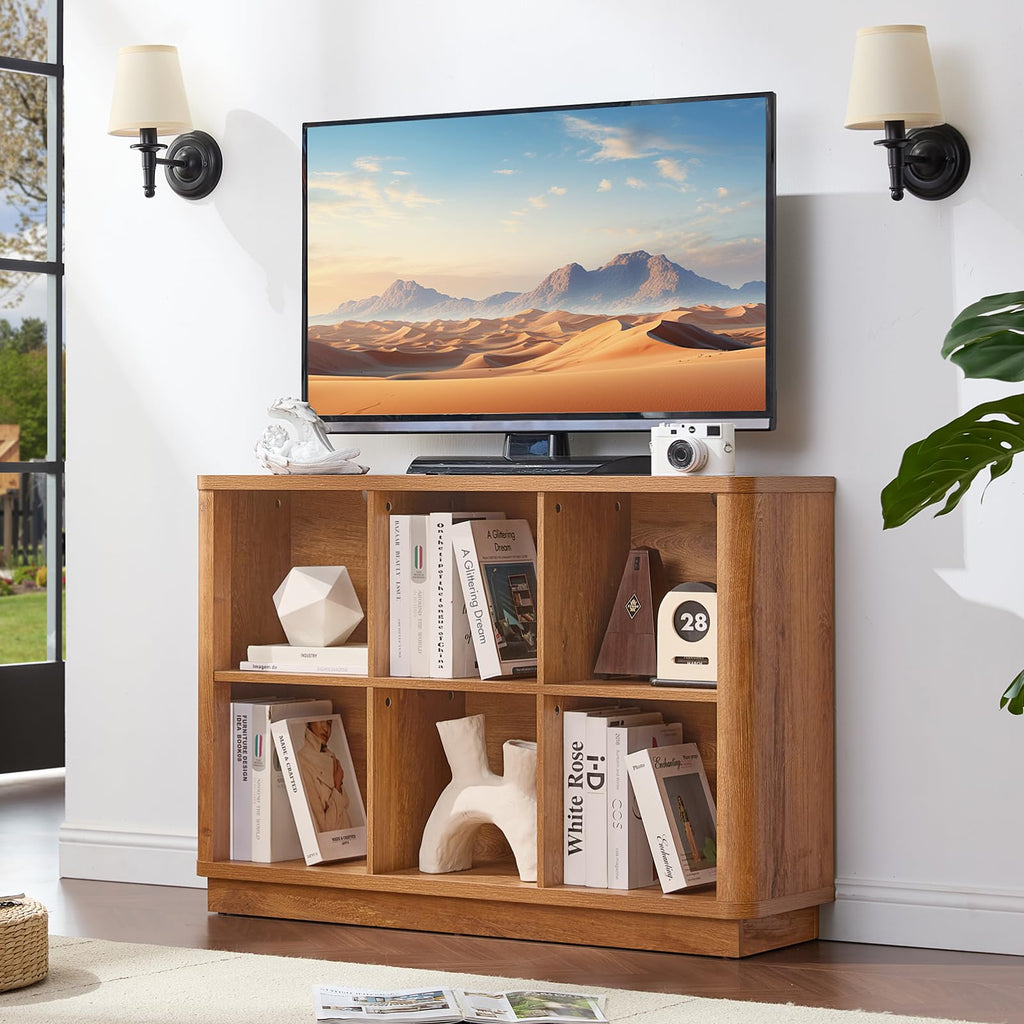 Horizontal wooden cube storage book shelf with curved edge, open cubbies and base.