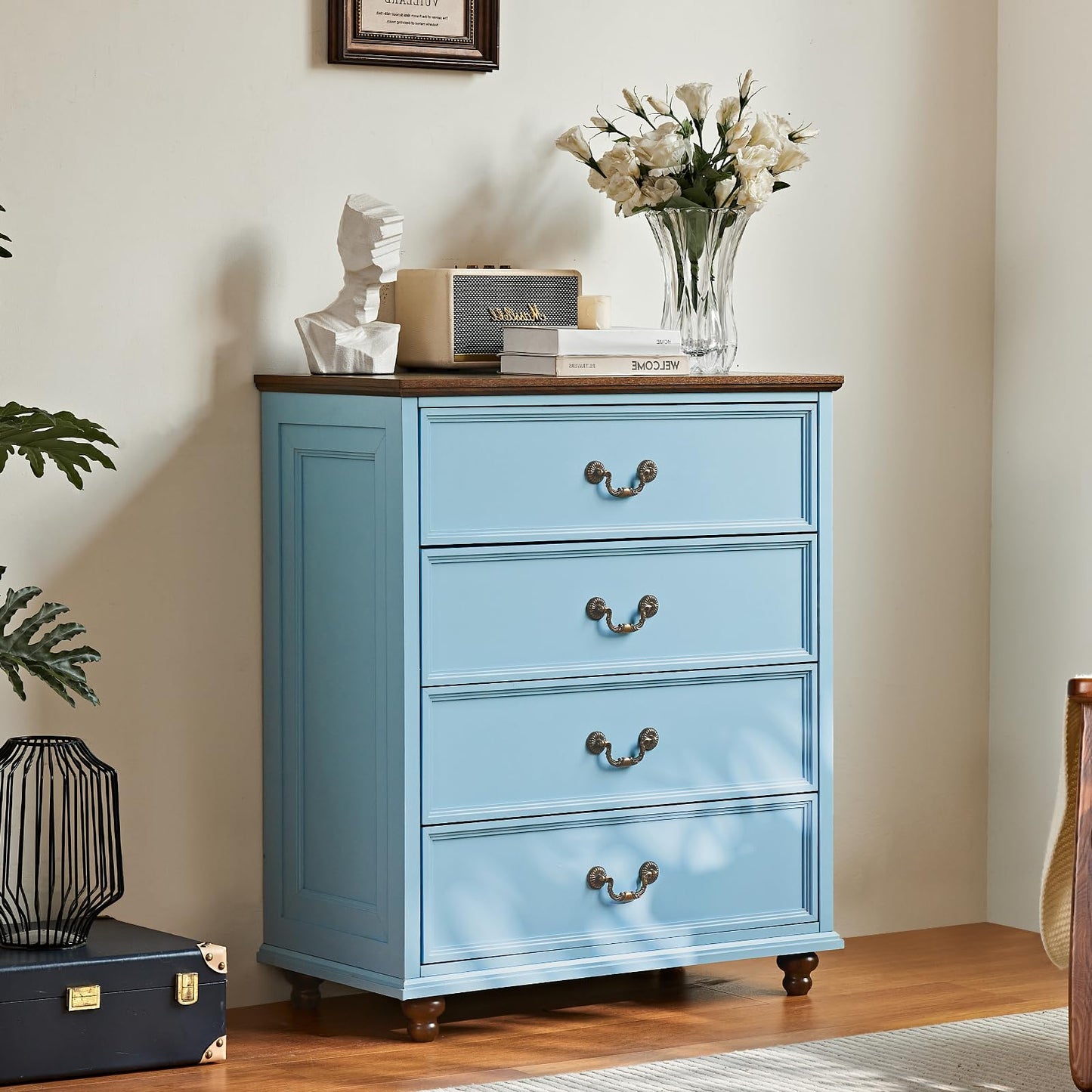 Blue farmhouse dresser with four drawers and curved metal pulls, on short wooden feet