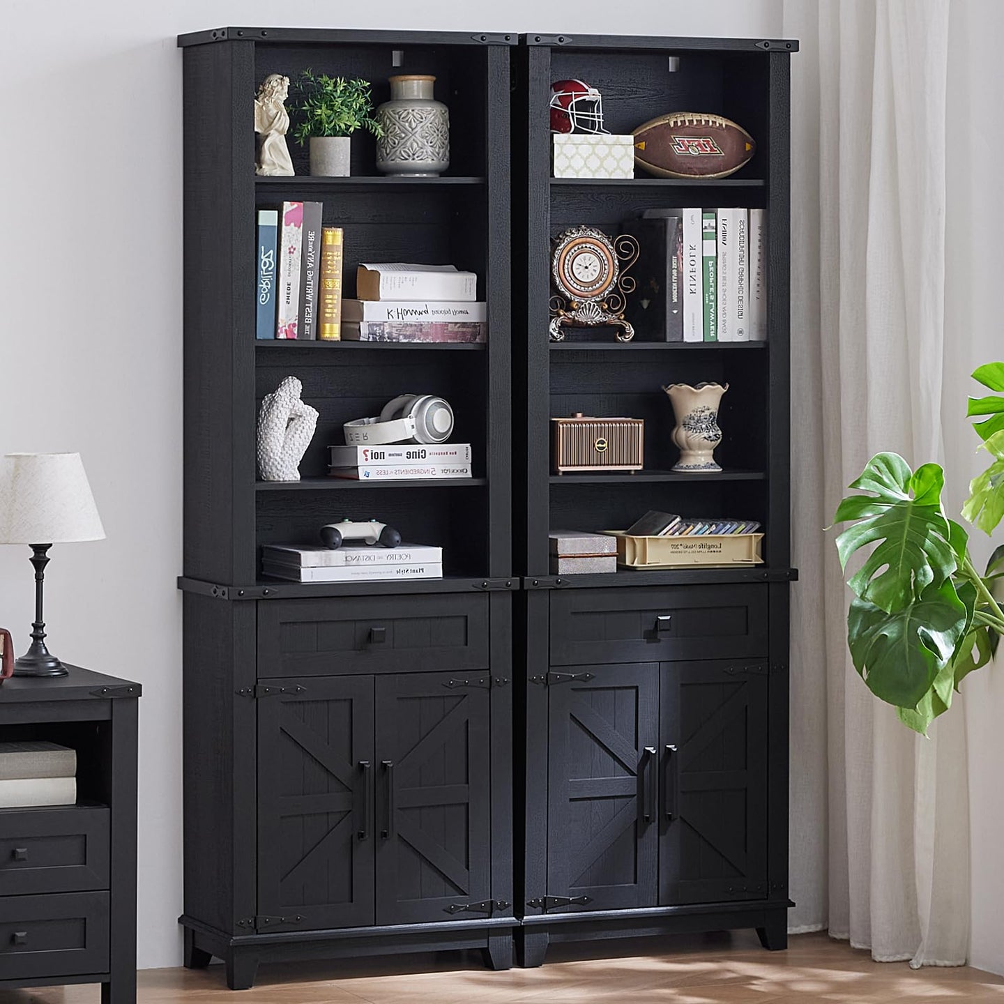 Black 7-tier bookshelf with open shelves, barn-style cabinet doors, and two drawers