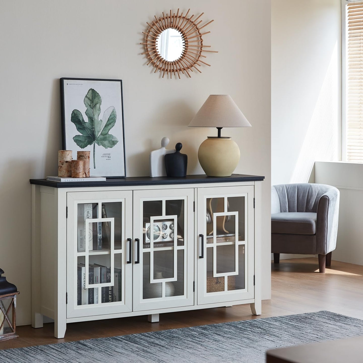 White buffet cabinet with glass doors, centered metal handles, and open storage compartments.