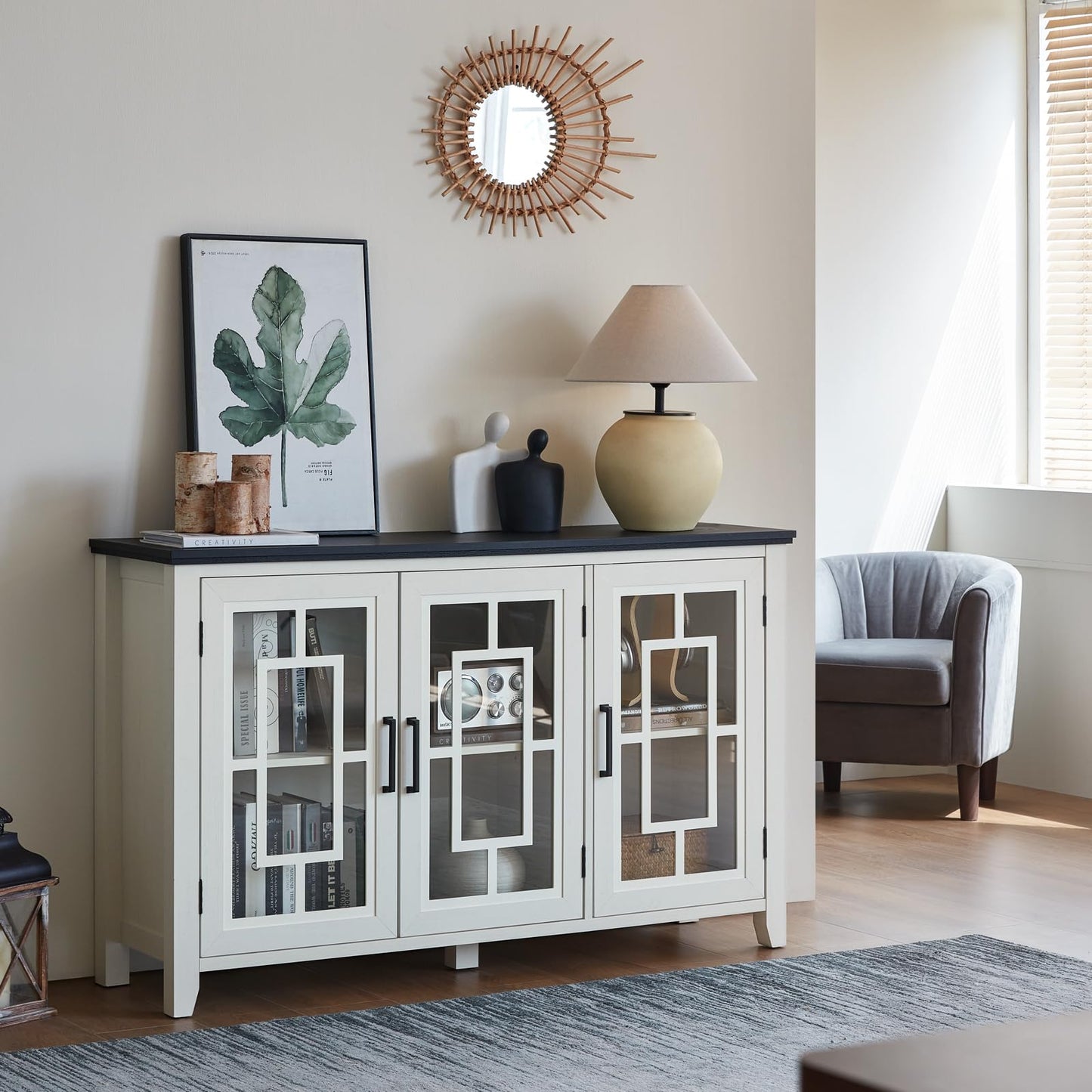 White buffet cabinet with glass doors, centered metal handles, and open storage compartments.