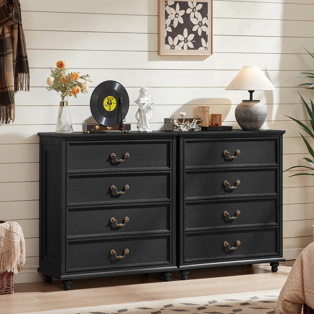 Black wooden dresser with four drawers and curved metal handles.
