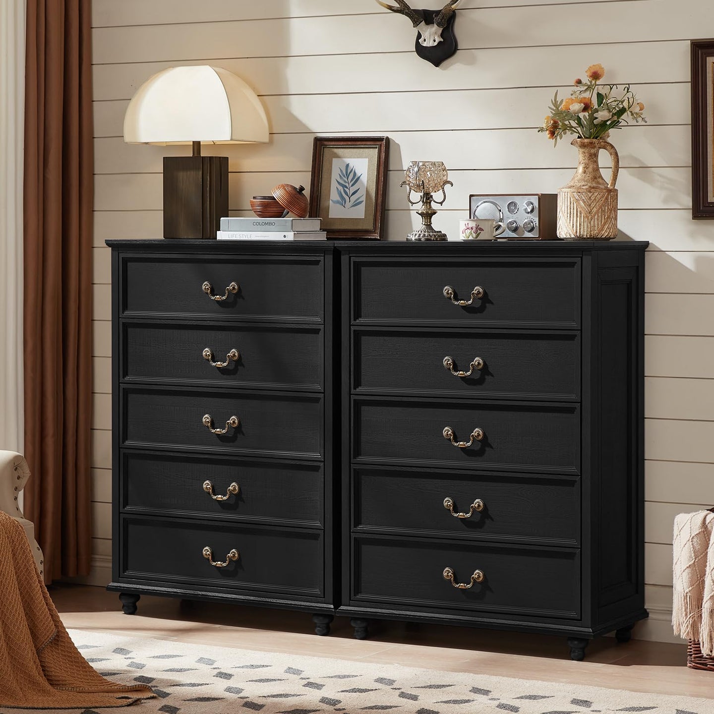 Black 4-drawer dresser cabinet pair with gold-tone handles and sturdy legs, front view.