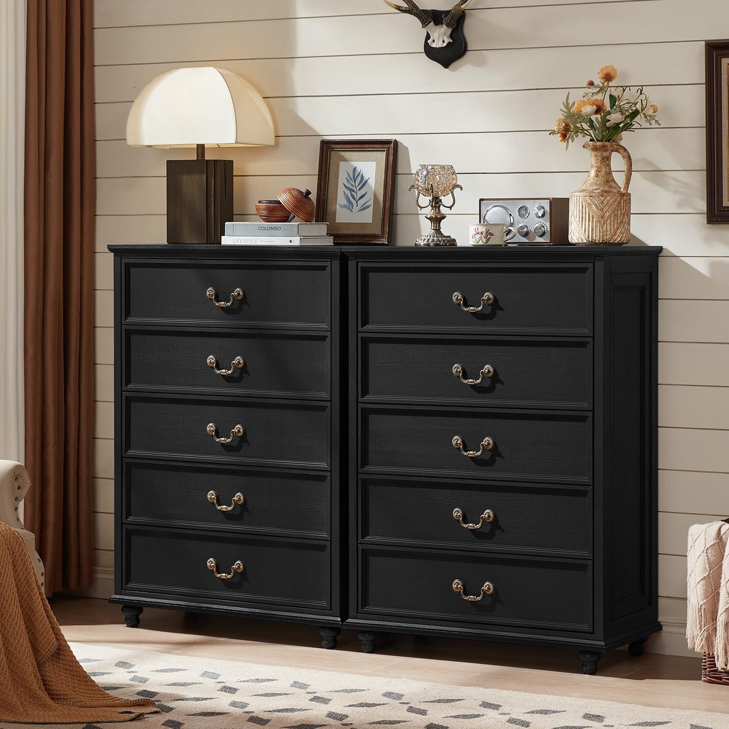Black 4-drawer dresser cabinet pair with gold-tone handles and sturdy legs, front view.