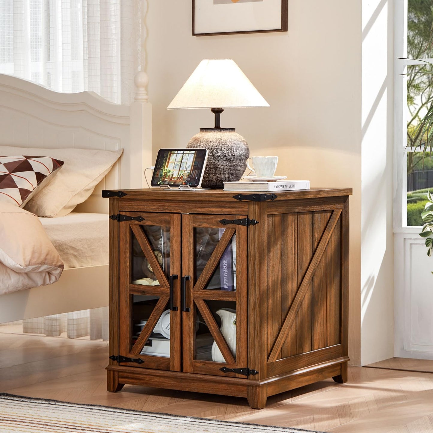 Brown farmhouse end table with black top, glass barn-style doors, and storage shelves