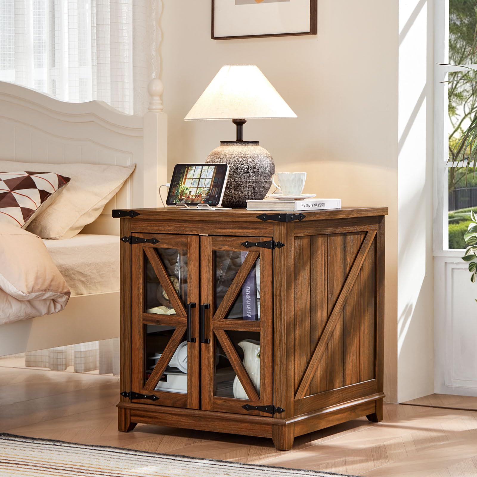 Brown farmhouse end table with black top, glass barn-style doors, and storage shelves