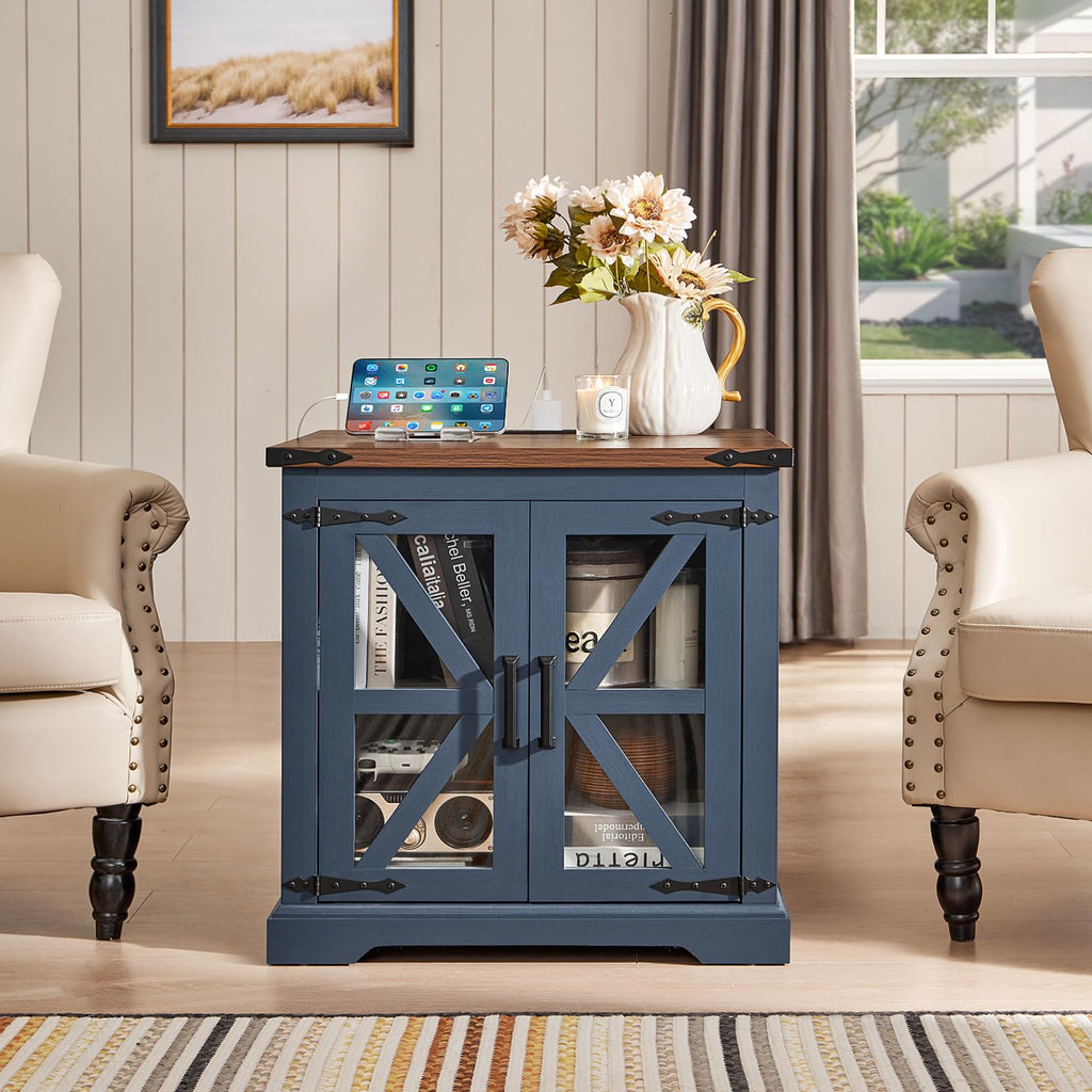 Navy blue bedside end table with cabinet doors and open shelves, tablet and mug on top