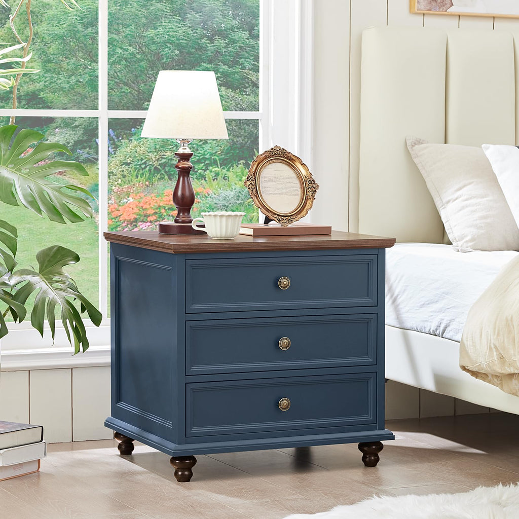 Dark blue dresser with three drawers and round metal knob pulls on turned feet