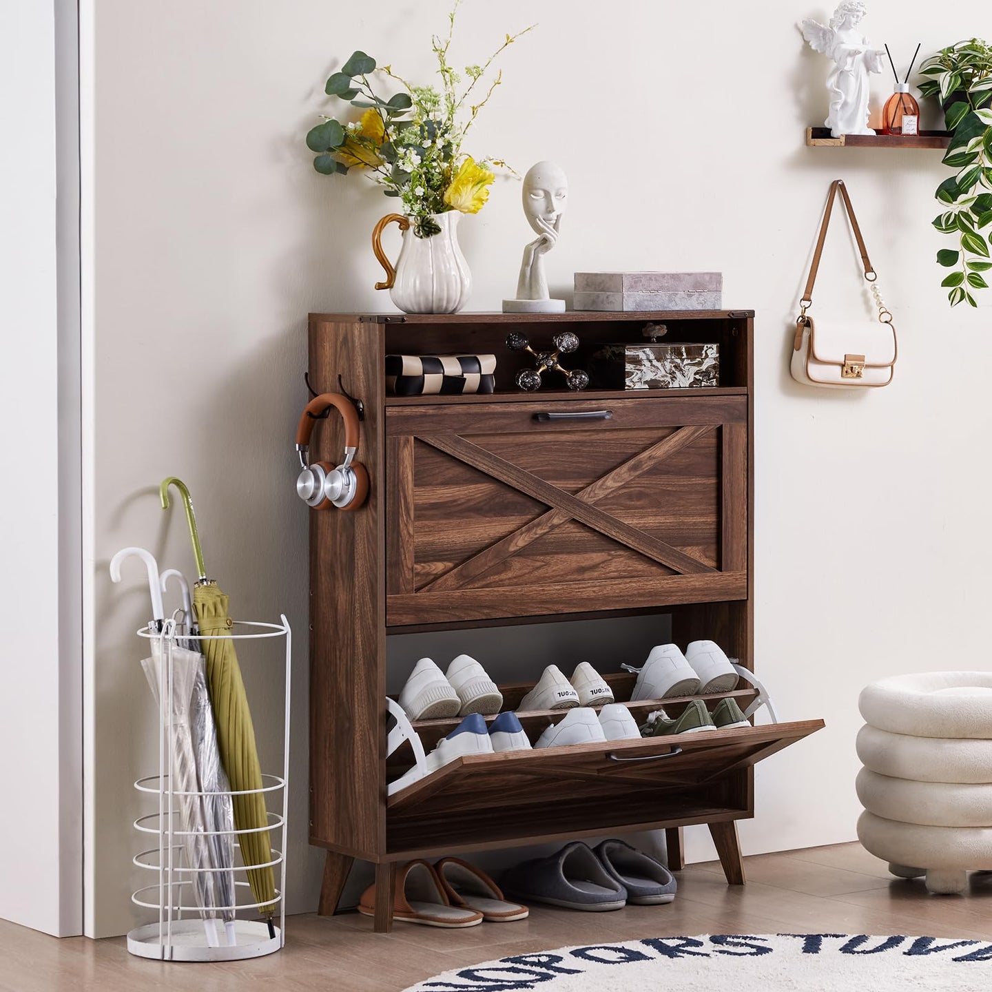 Freestanding shoe storage cabinet with flip drawer open, showing shoes inside