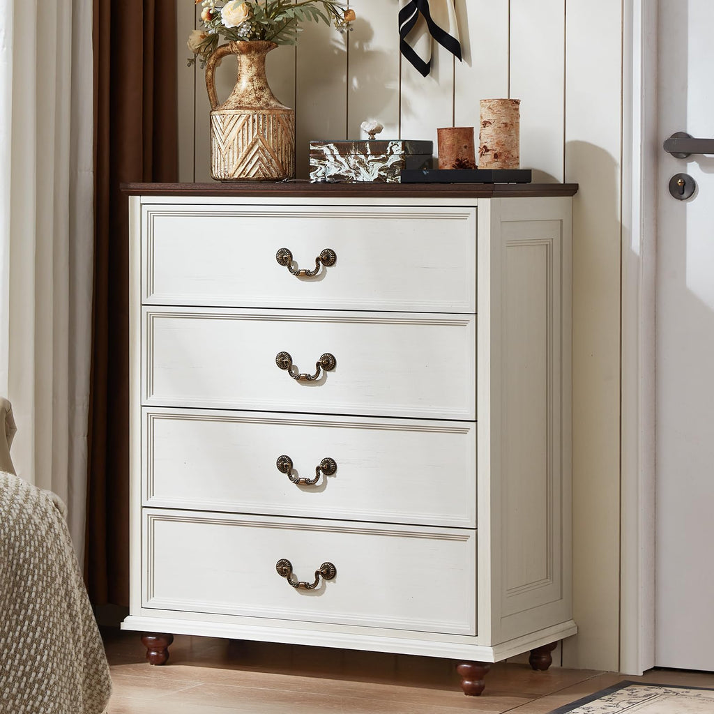 White 4-drawer dresser with brass cup pulls and short wooden feet.