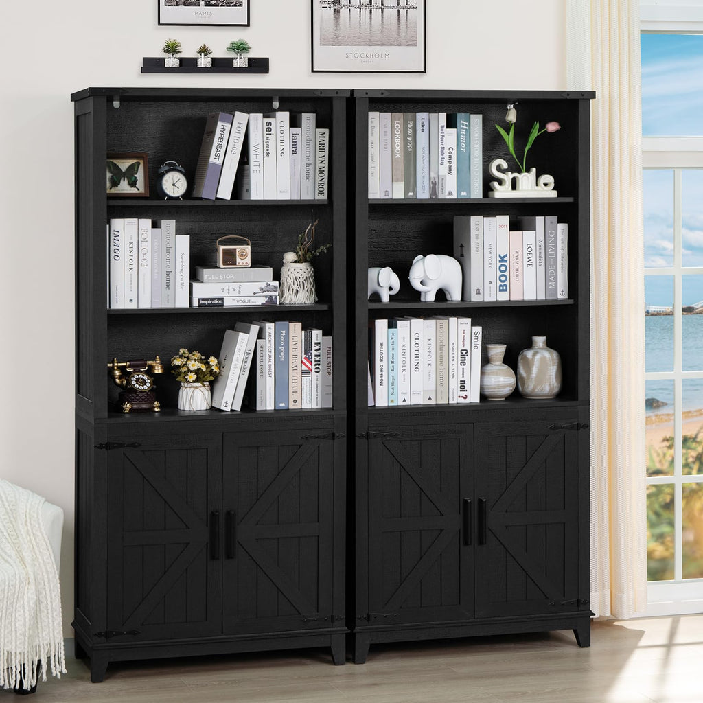 Black bookcase with cabinet doors, open top and middle shelves holding books and decor