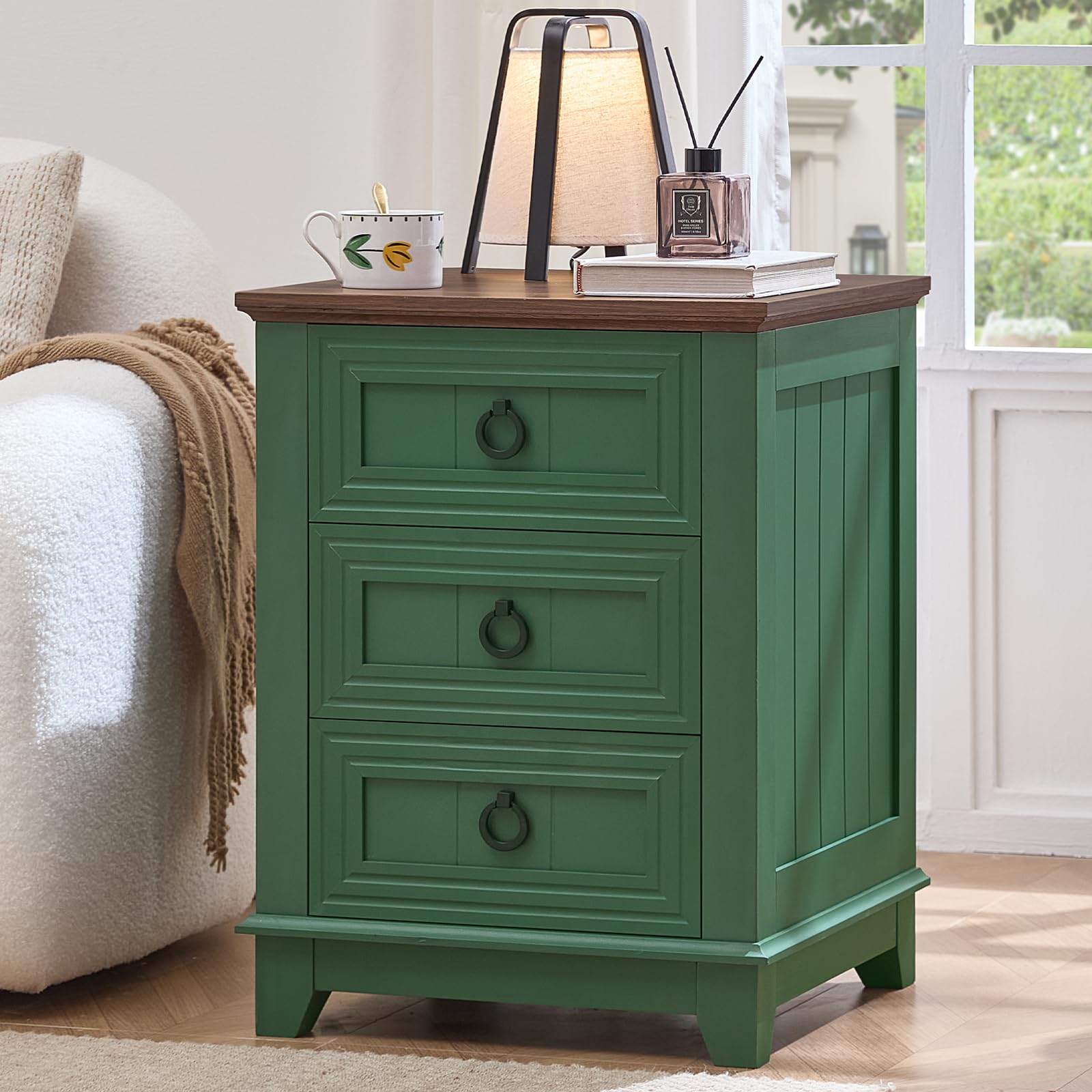 Green dresser with three drawer fronts and round metal knobs