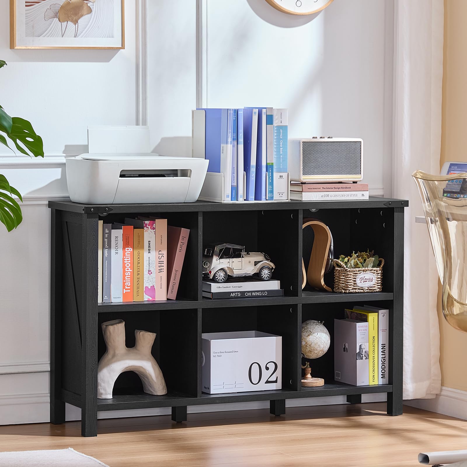 Black low bookcase with open cubby shelves for books and decorative items
