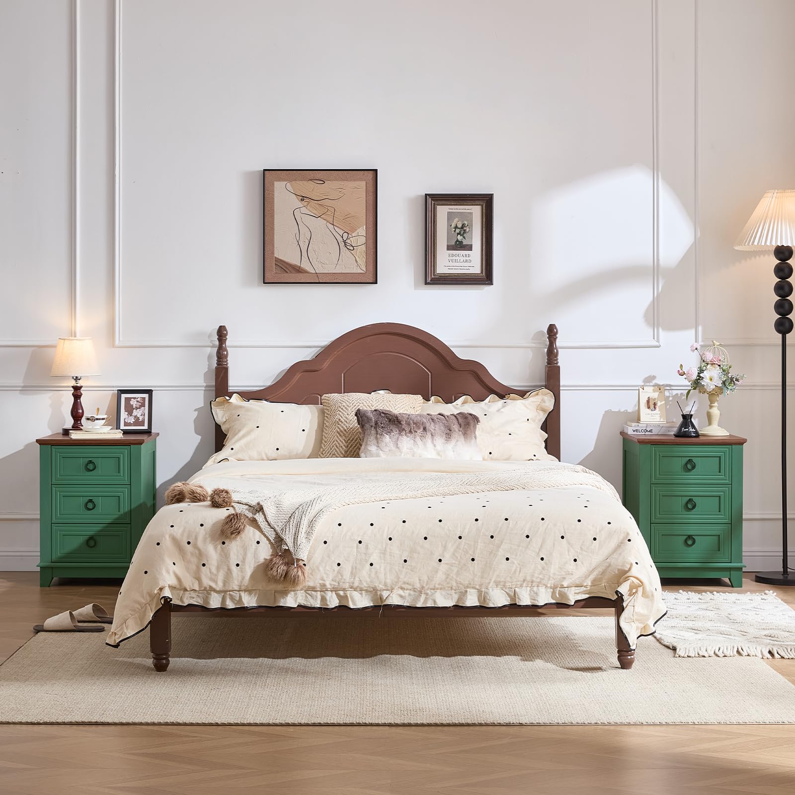 Green 3-drawer nightstand with metal ring pulls and dark wood top beside bed