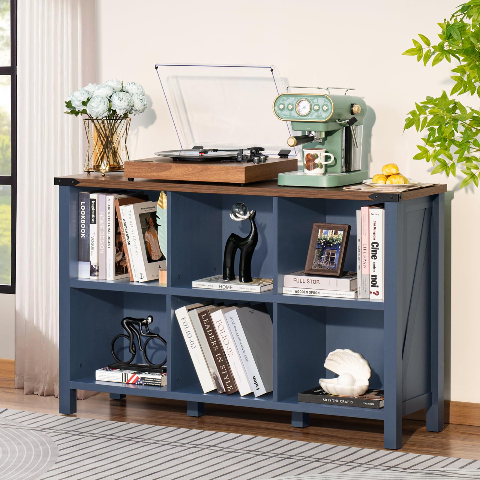 Blue-gray wood bookcase with open compartments for books, decor, and baskets