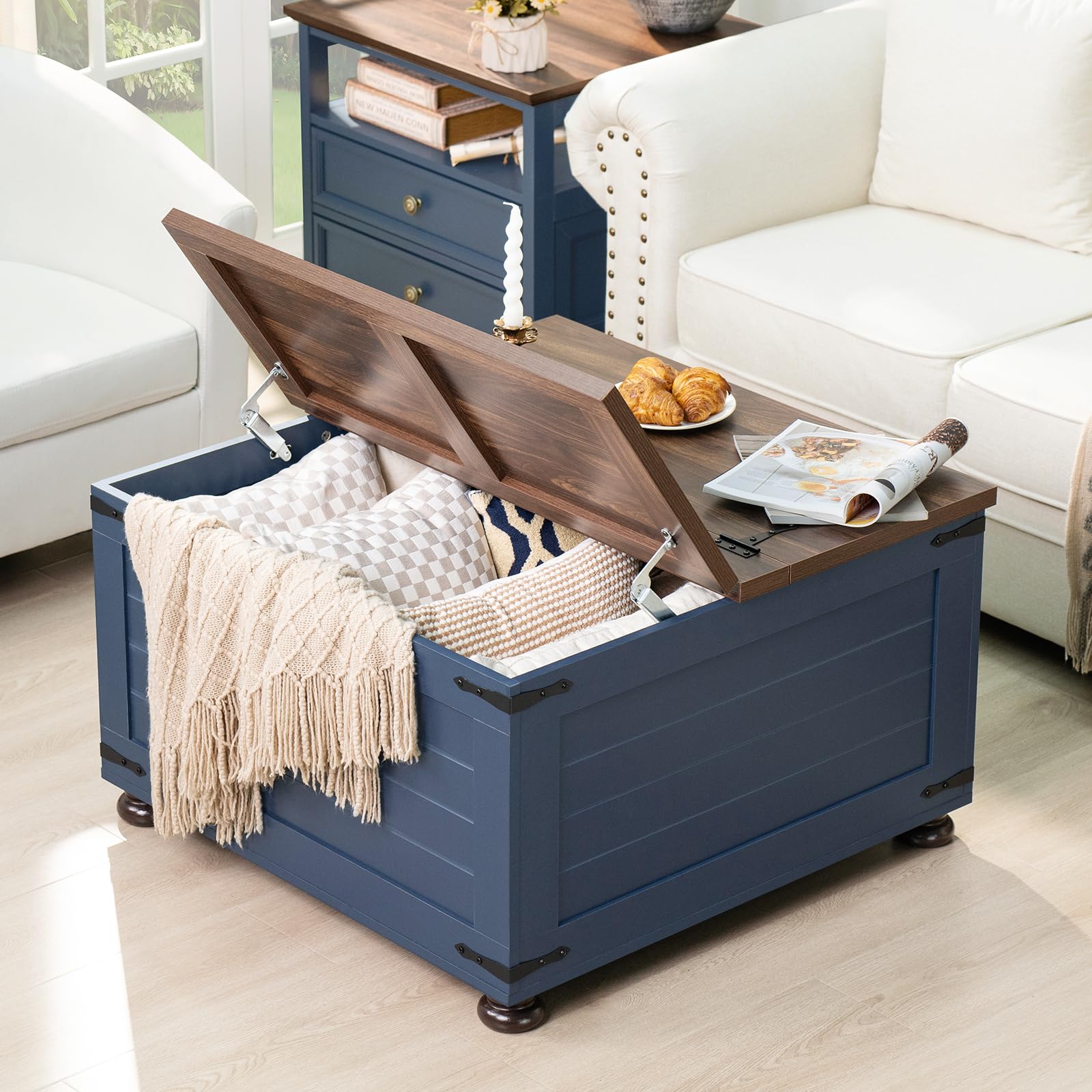 Blue square coffee table with hinged lift-top open, showing hidden storage
