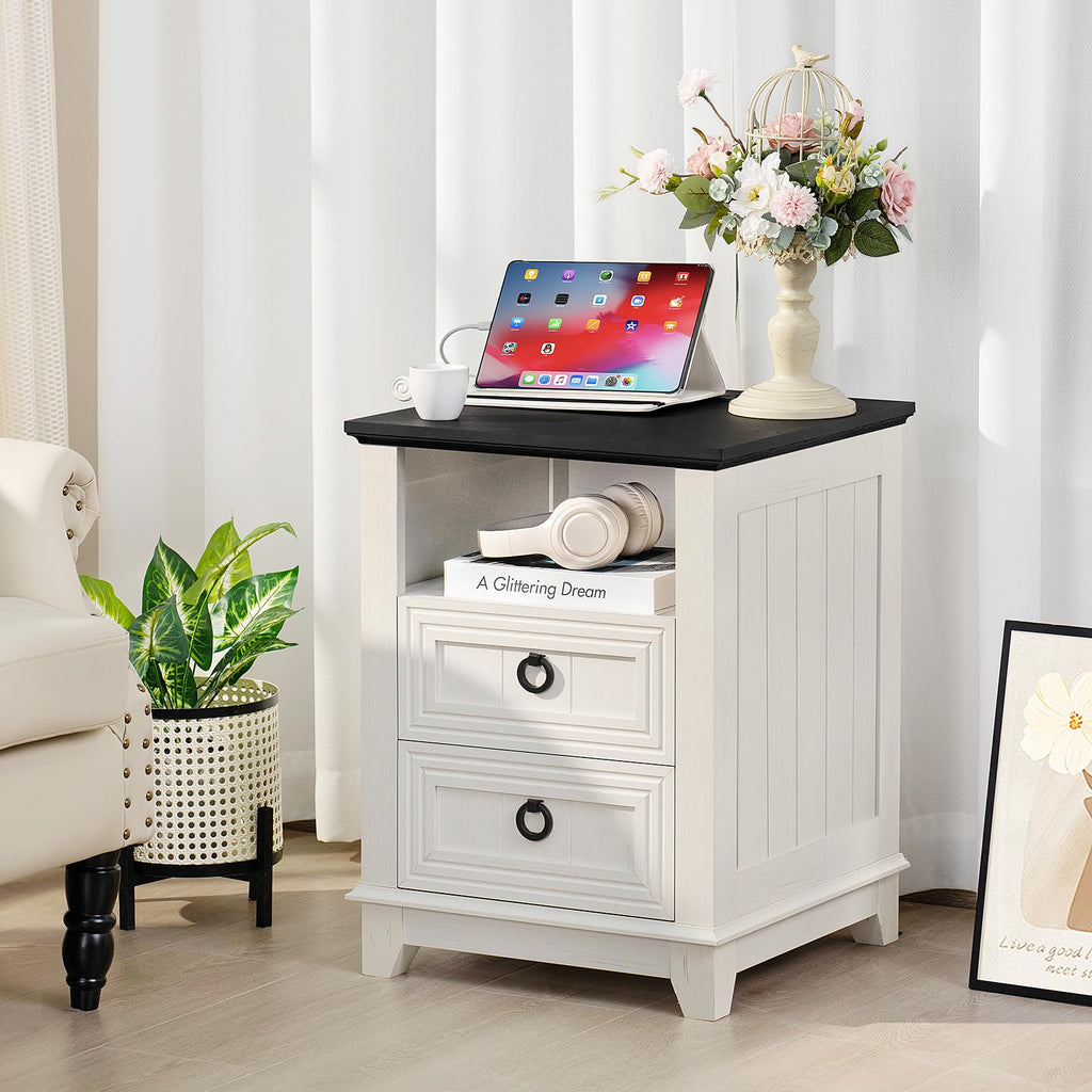 White nightstand cabinet with black top and two drawers with metal ring pulls