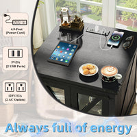 Black farmhouse end table with charging ports on tabletop and glass door panels