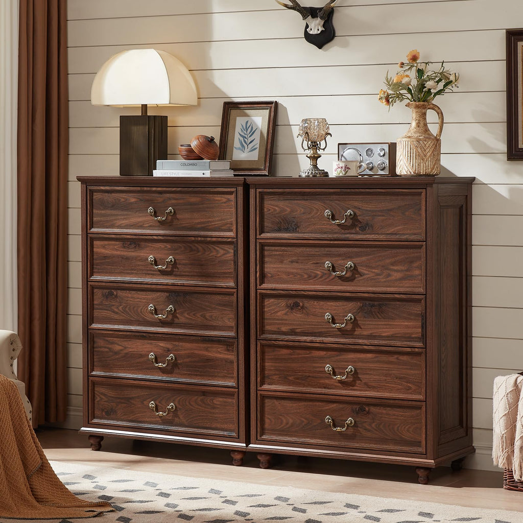 Dark wood dresser with multiple drawers, brass-tone pulls, and low wooden feet