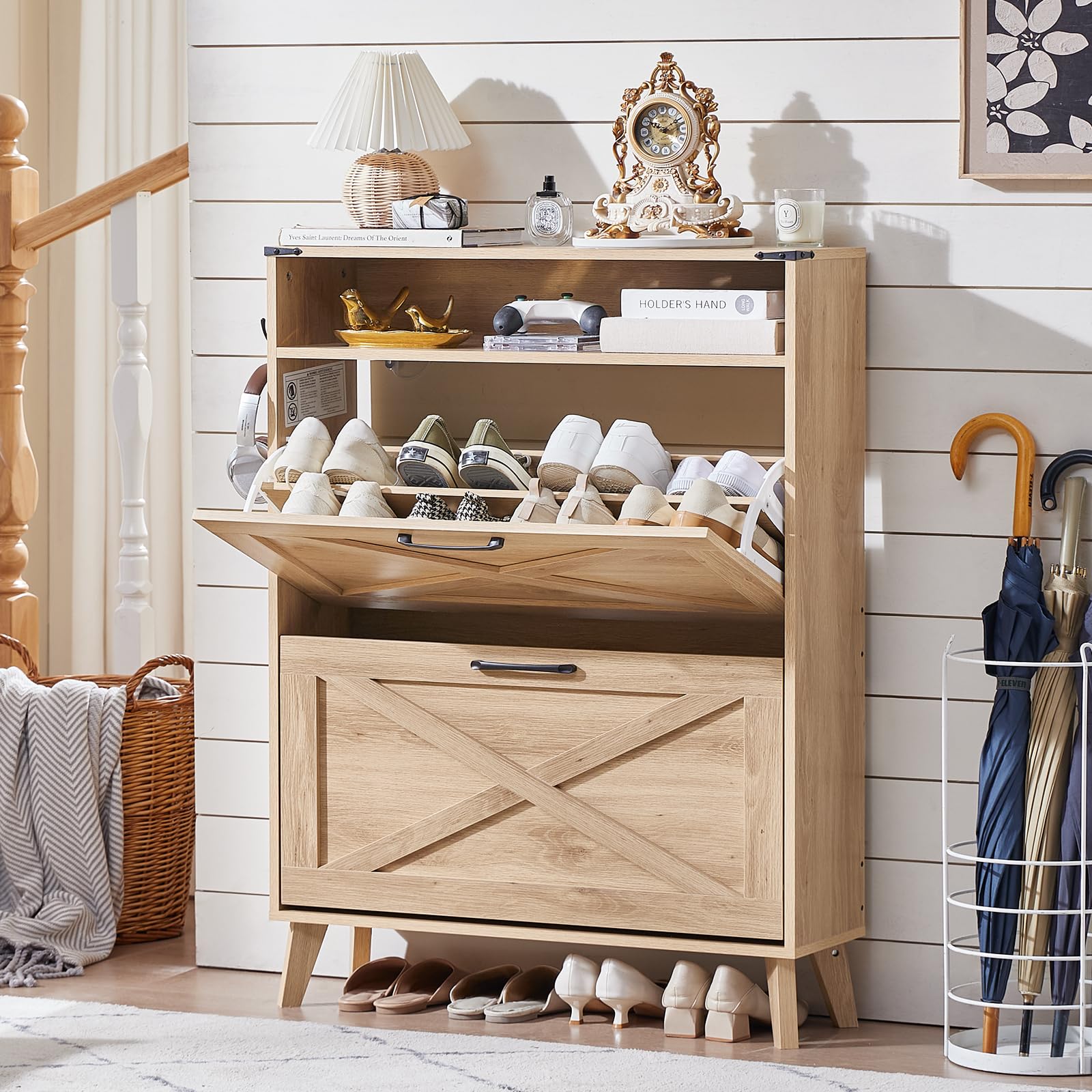 Light wood shoe storage cabinet with top open shelf and front flip drawer, holding shoes