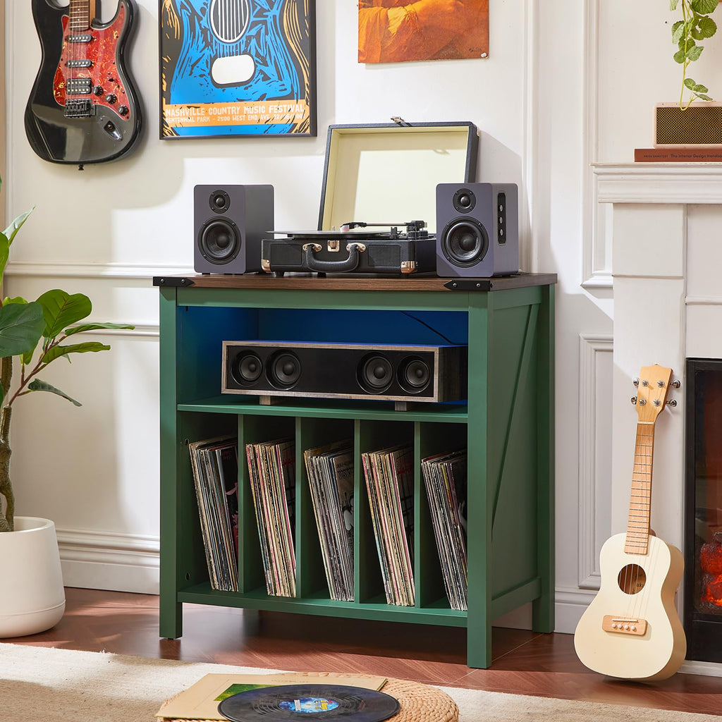 Green record player cabinet with vinyl record storage shelves and speaker setup on top.
