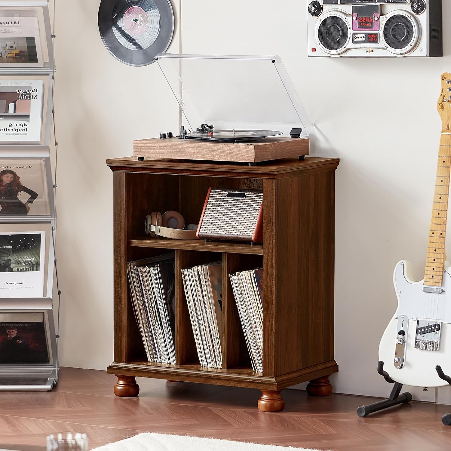 Brown wood record player stand with turntable on top and vinyl records on front cabinet shelf