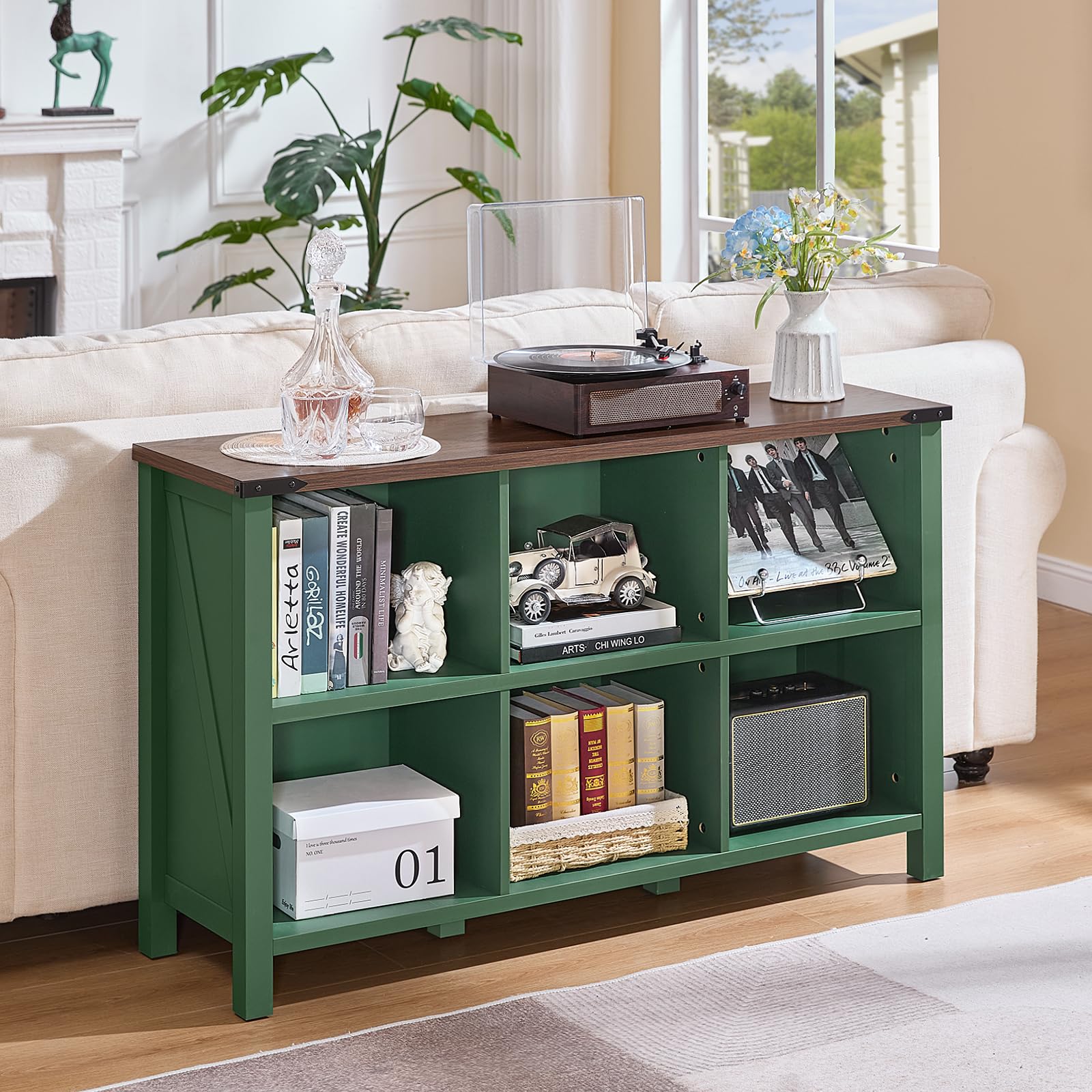 Green console bookcase with open shelves and cubby compartments on solid legs