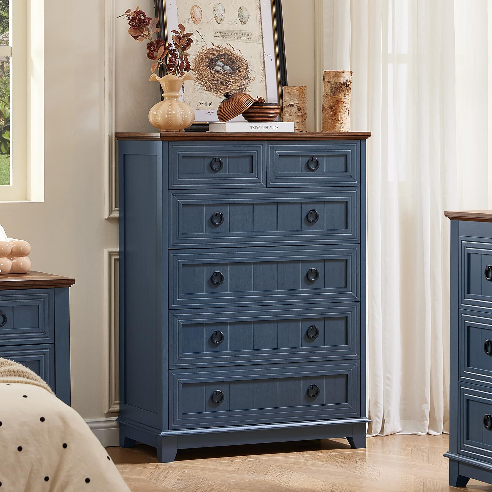 Blue painted wood dresser with five drawers and round metal knobs.