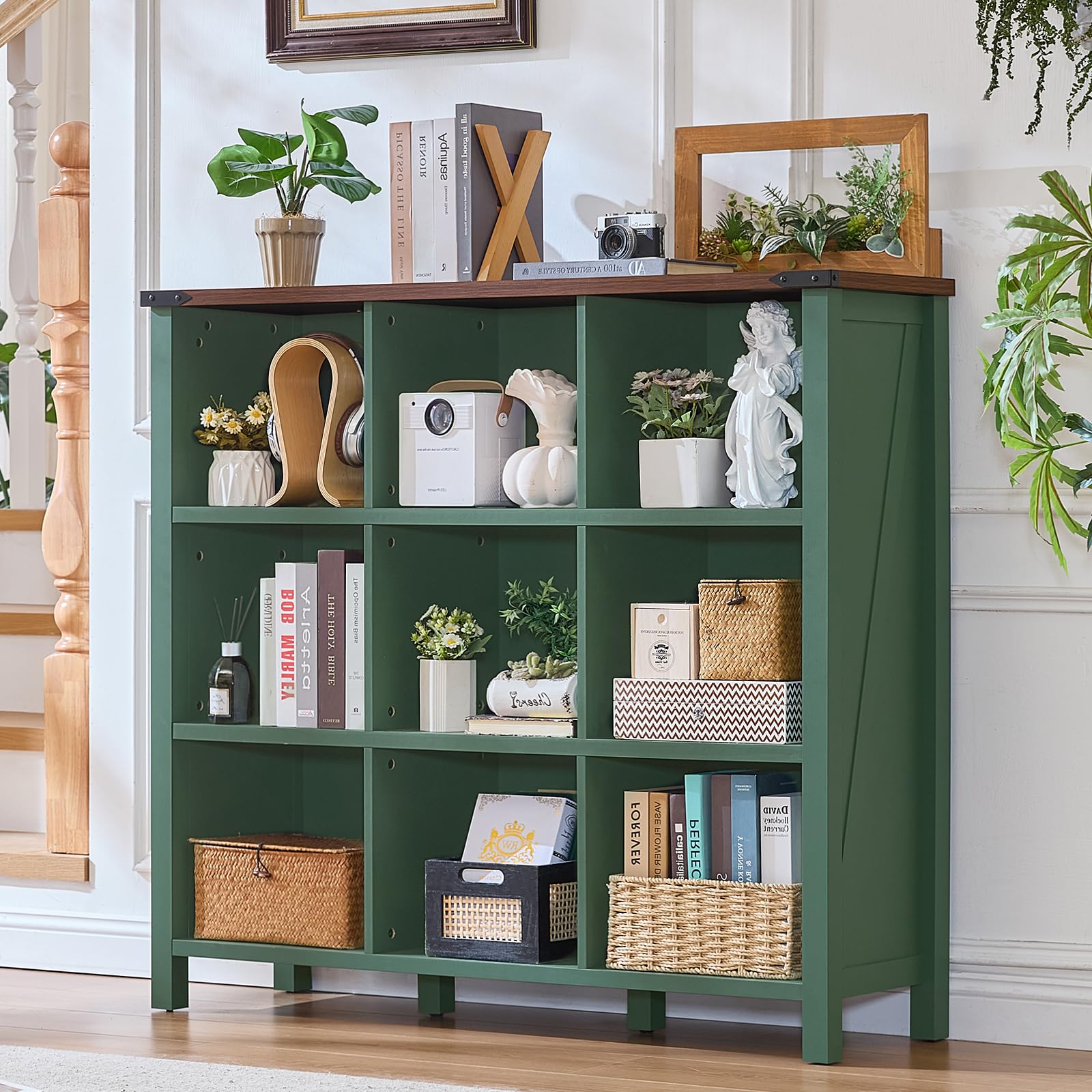 Green console bookcase with open cubbies and shelves, styled with books and decor