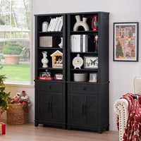 Black tall bookcase with open shelves, drawer storage, and barn doors in front