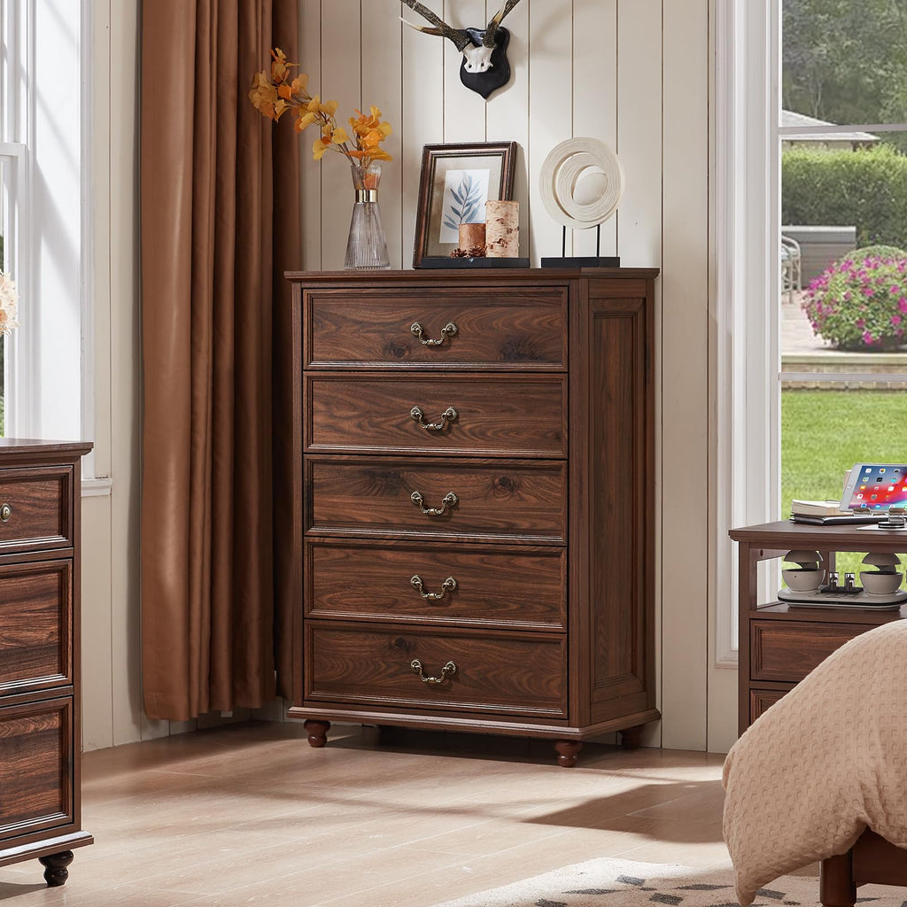 White dresser with multiple drawers, brass-tone pulls, and short wooden legs