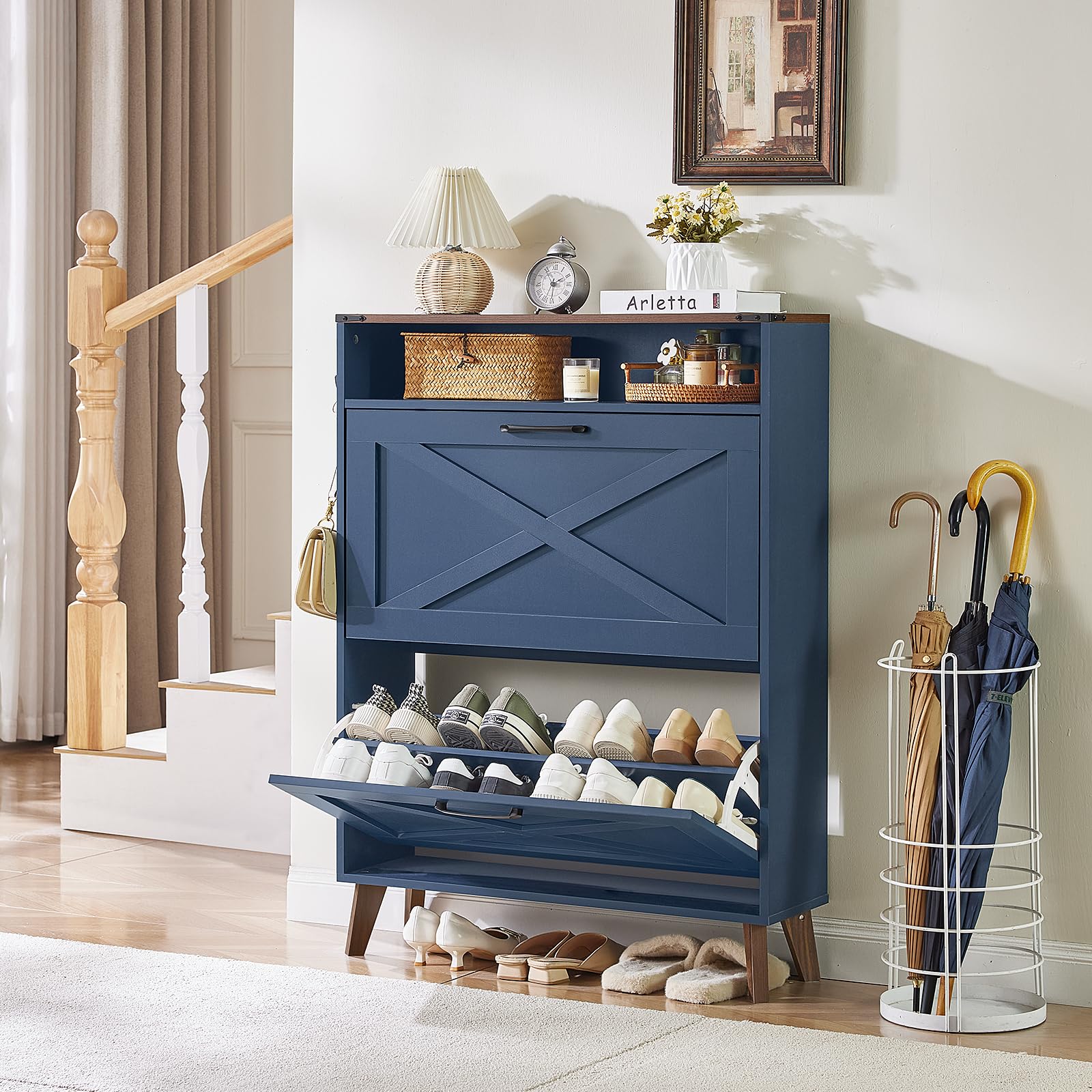 Navy shoe storage cabinet with open bottom shelf and arranged shoes
