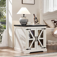 White nightstand with glass barn doors, black top, and built-in storage shelves.