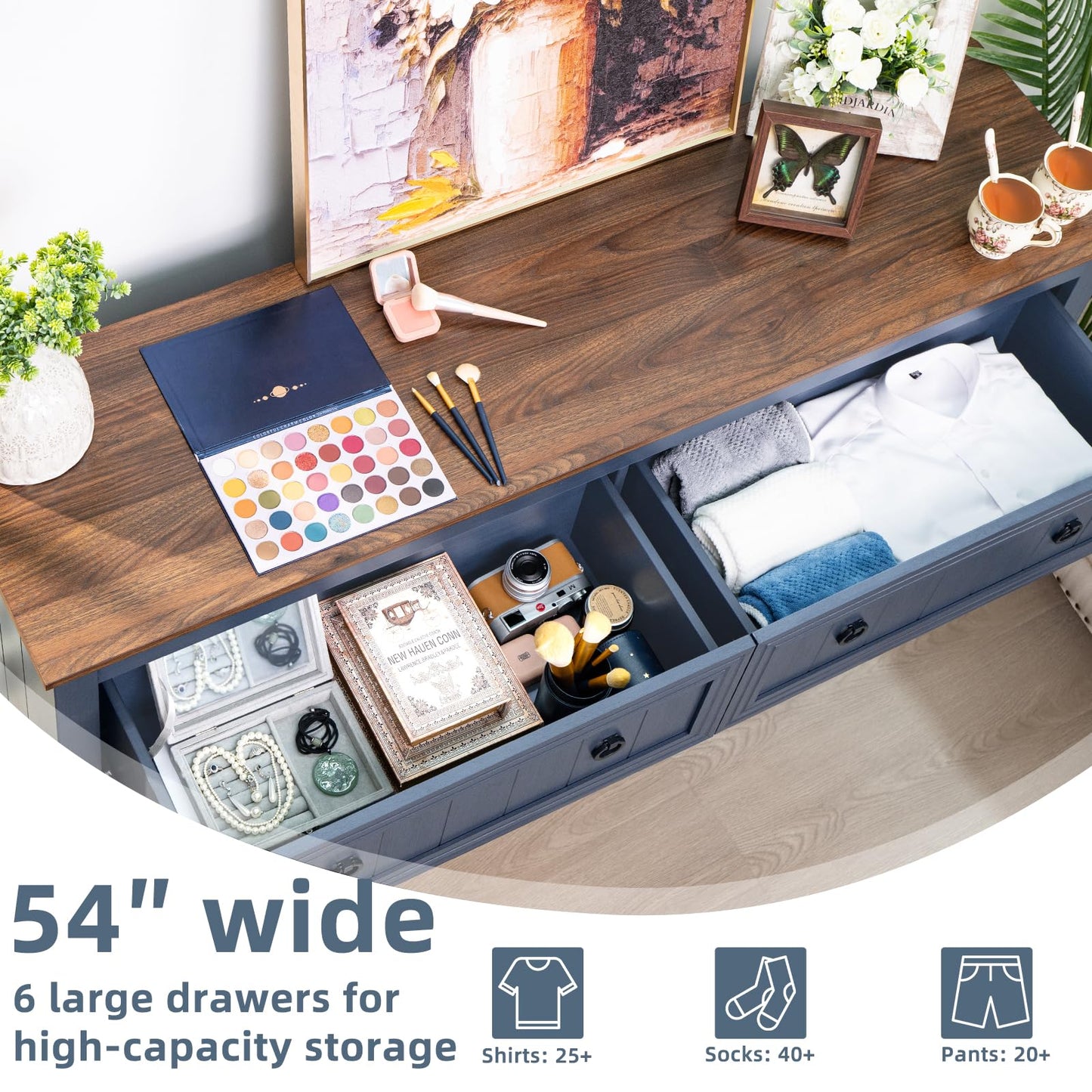 Blue dresser with multiple open drawers and round knobs, interior storage space visible
