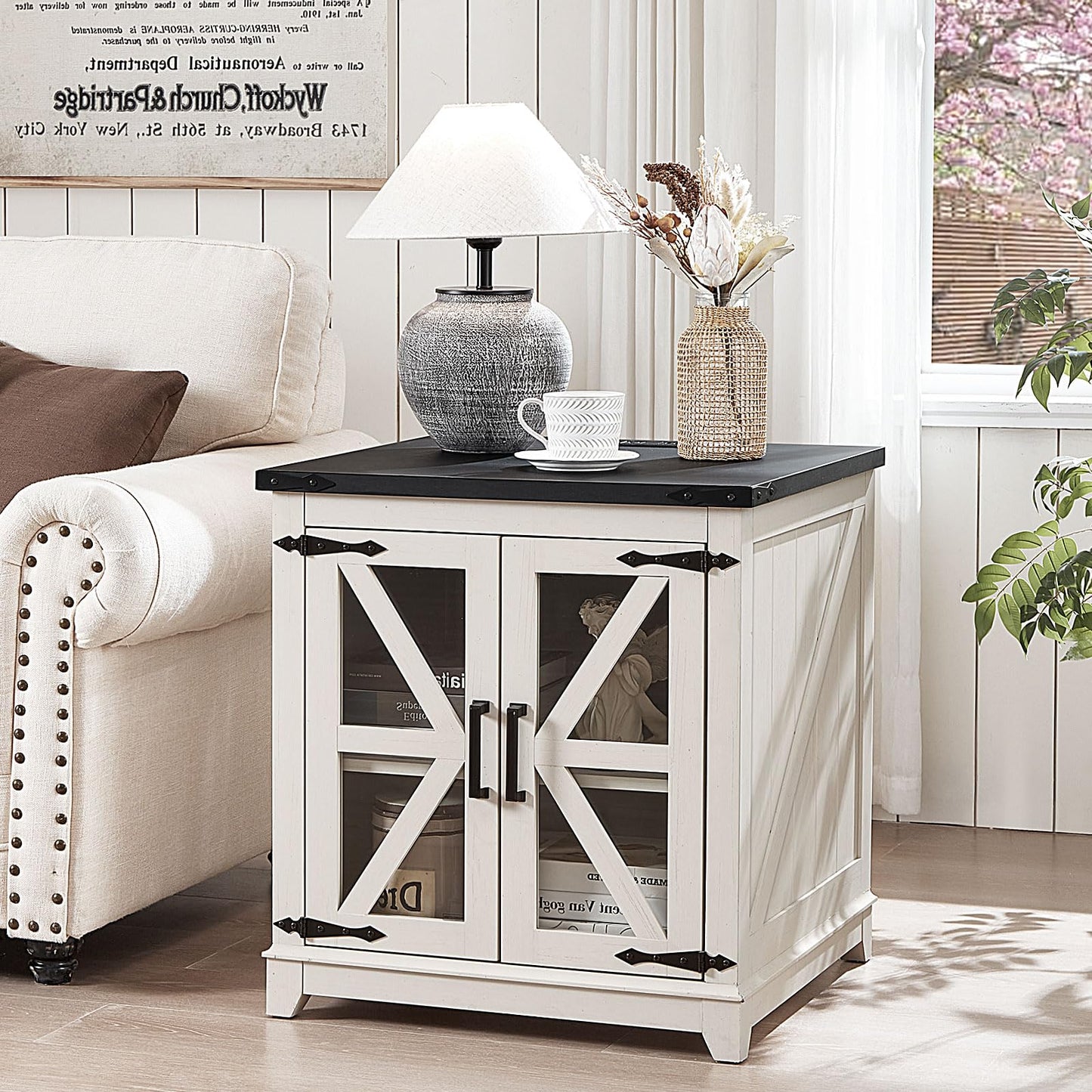 White wood end table with black top and glass barn-style doors for storage