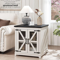 White wood end table with black top and glass barn-style doors for storage