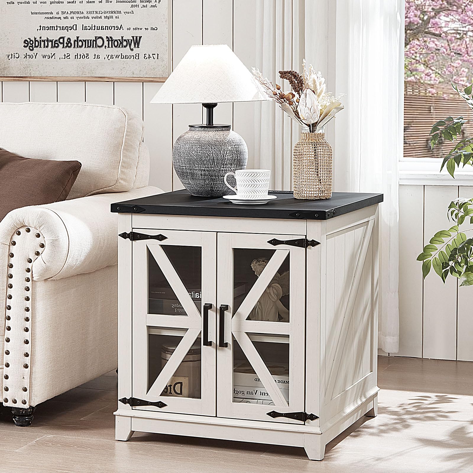White wood end table with black top and glass barn-style doors for storage