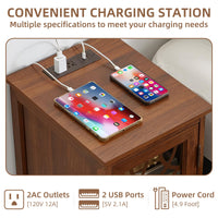 Wood bedside table with glass door showing phone chargers and cables on top